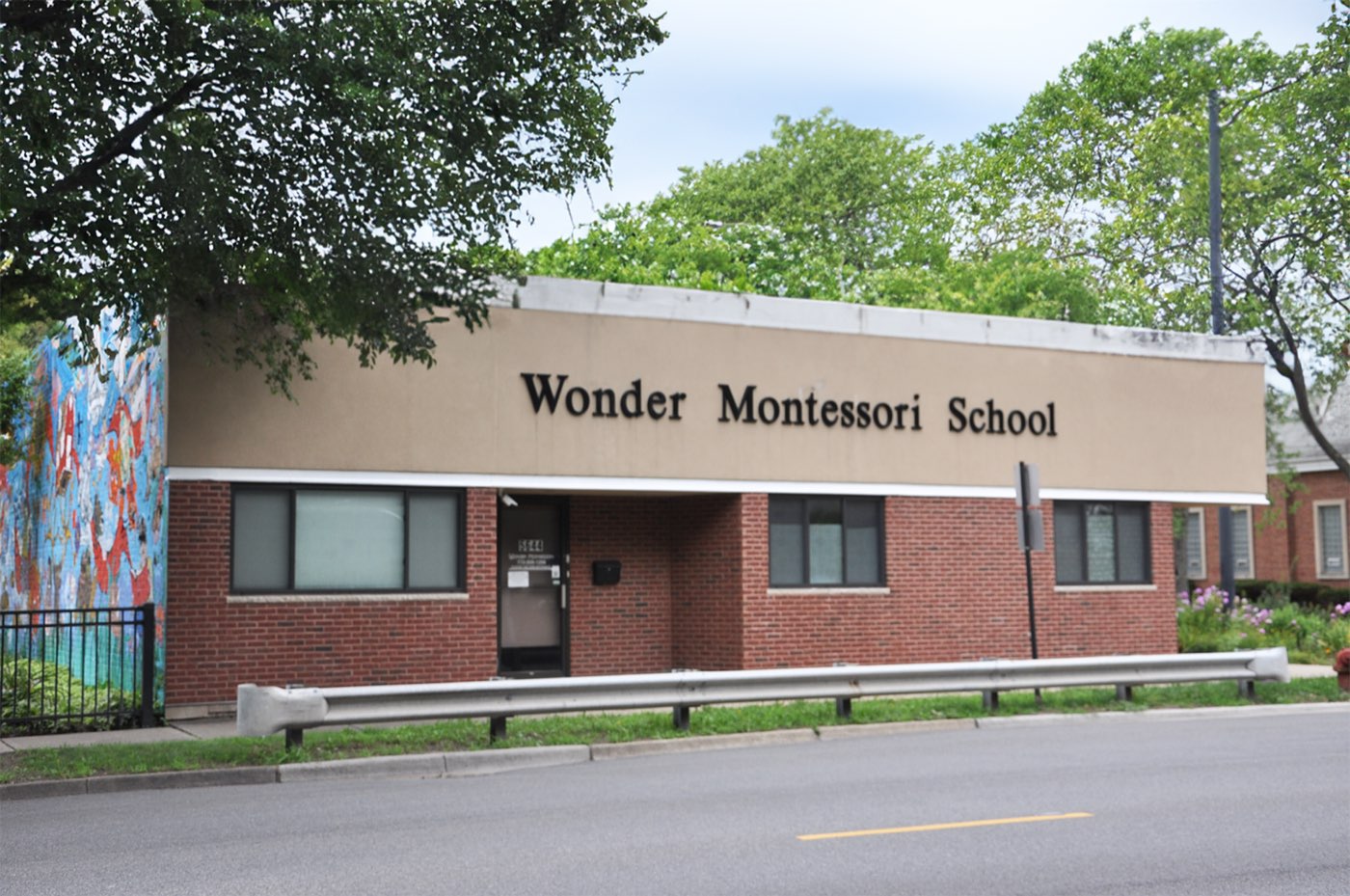 The Wonder Montessori School building, a brick single-storey school with a painted mural along one wall